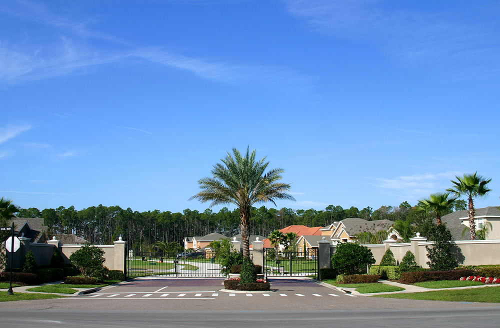 Gated community entrance with palm trees